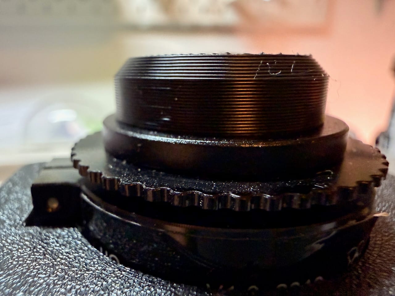 A black 3D-printed baffle fitted around the fisheye lens to shade it from stray light, like a lens hood